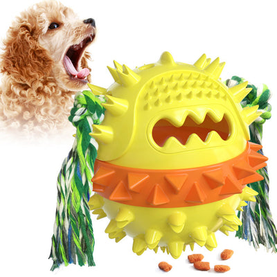 Yellow spiky dog toy with orange band and green rope, designed for chewing and treat dispensing, next to a yawning puppy. - Image 8