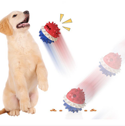 Yellow spiky dog toy with orange band and green rope, designed for chewing and treat dispensing, next to a yawning puppy. - Image 5