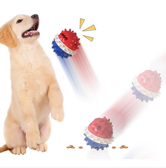 Yellow spiky dog toy with orange band and green rope, designed for chewing and treat dispensing, next to a yawning puppy. - Image 5