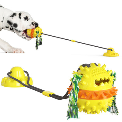 Dalmatian puppy playing with a red, white, and blue suction cup dog toy with a spiked ball and rope tassels. - Image 7