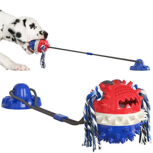 Dalmatian puppy playing with a red, white, and blue suction cup dog toy with a spiked ball and rope tassels. - Image 9