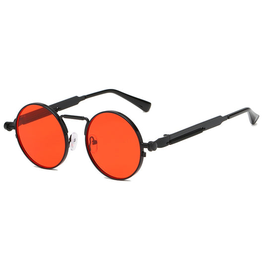 Round red lens sunglasses with a black metal frame and unique spring-leg temples on a white background. - Image 8