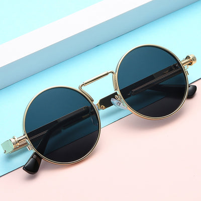 Round red lens sunglasses with a black metal frame and unique spring-leg temples on a white background. - Image 7