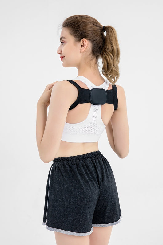 White posture correction belt with adjustable shoulder straps and a central rectangular pad for back support. - Image 16