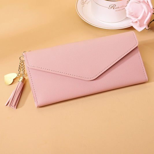 Bolso de mano con borlas decorativas