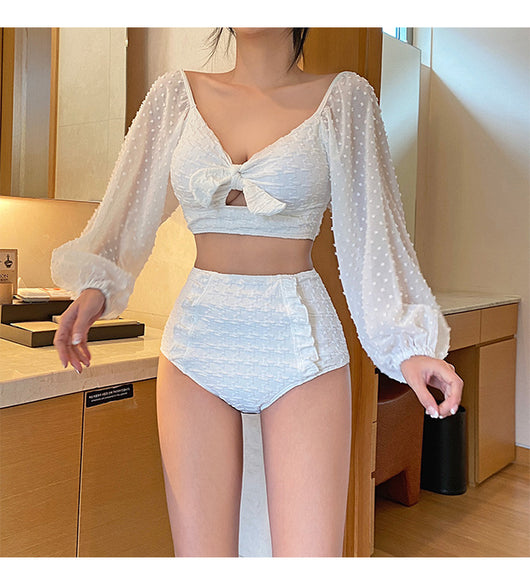White long-sleeve bikini with a bow-front crop top and high-waisted bottoms with ruffled sides. - Image 8