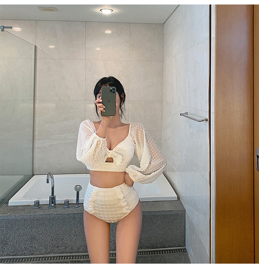 White long-sleeve bikini with a bow-front crop top and high-waisted bottoms with ruffled sides. - Image 10