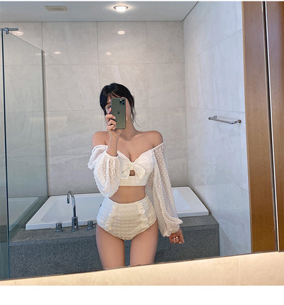 White long-sleeve bikini with a bow-front crop top and high-waisted bottoms with ruffled sides. - Image 12