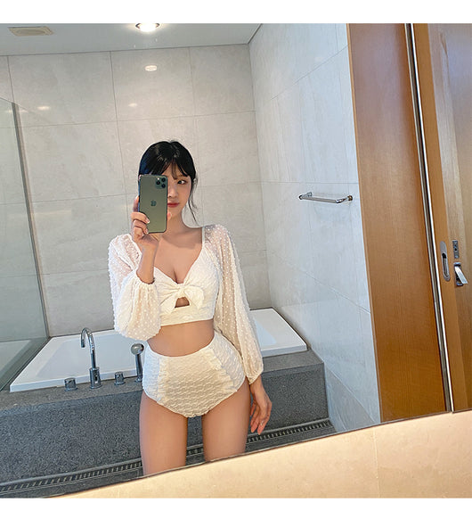 White long-sleeve bikini with a bow-front crop top and high-waisted bottoms with ruffled sides. - Image 4