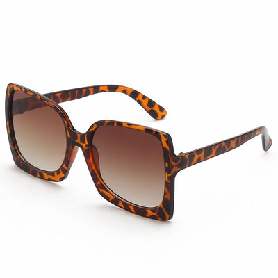 Oversized square-frame sunglasses with translucent peach frames and brown gradient lenses on a white background. - Image 12