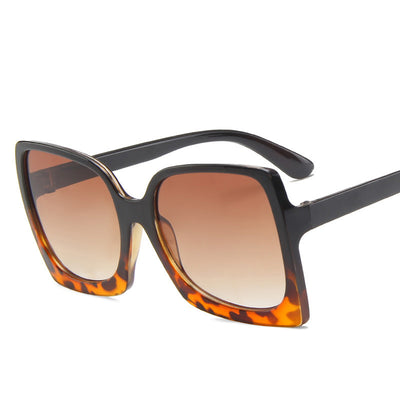 Oversized square-frame sunglasses with translucent peach frames and brown gradient lenses on a white background. - Image 5
