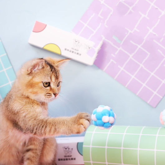 Three plush elastic bell balls for cats in a white gift box. Balls are pink/green, blue/white, and brown/white. - Image 6