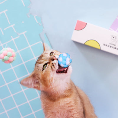 Three plush elastic bell balls for cats in a white gift box. Balls are pink/green, blue/white, and brown/white. - Image 7