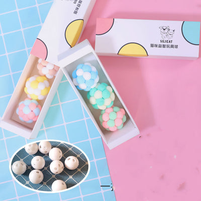 Three plush elastic bell balls for cats in a white gift box. Balls are pink/green, blue/white, and brown/white. - Image 9