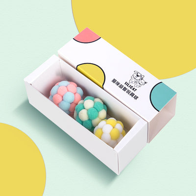 Three plush elastic bell balls for cats in a white gift box. Balls are pink/green, blue/white, and brown/white. - Image 3