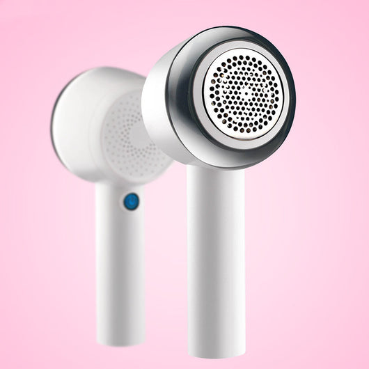 White rechargeable fabric shaver with a circular perforated head and a blue power button on the handle. - Image 7