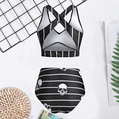 Woman in a black two-piece swimsuit with white skull and bone prints, featuring a high-waisted bottom and a bow-front top. - Image 7