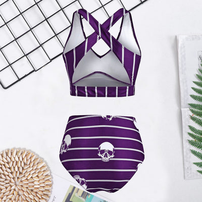 Woman in a black two-piece swimsuit with white skull and bone prints, featuring a high-waisted bottom and a bow-front top. - Image 10