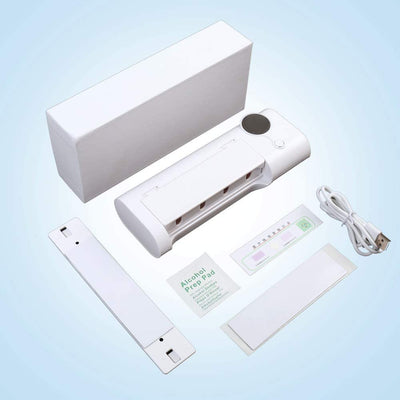 White toothbrush disinfector with UV light, USB cable, alcohol prep pad, and mounting strips on a light blue background. - Image 10