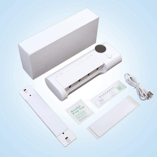 White toothbrush disinfector with UV light, USB cable, alcohol prep pad, and mounting strips on a light blue background. - Image 10
