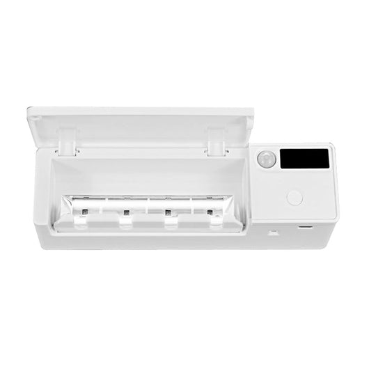 White toothbrush disinfector with UV light, USB cable, alcohol prep pad, and mounting strips on a light blue background. - Image 16