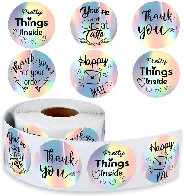 Roll of round holographic rainbow laser stickers with messages like 'Thank you', 'Pretty Things Inside', and 'Happy Mail'.