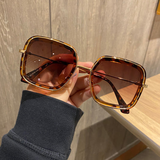 Retro big frame square brown sunglasses for women with white outer frames and gold-toned inner rims.