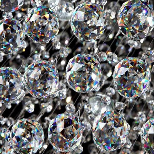 Clear faceted crystal ball bead, possibly K9 crystal, with a hole for stringing, against a dark background. - Image 11