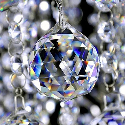 Clear faceted crystal ball bead, possibly K9 crystal, with a hole for stringing, against a dark background. - Image 7
