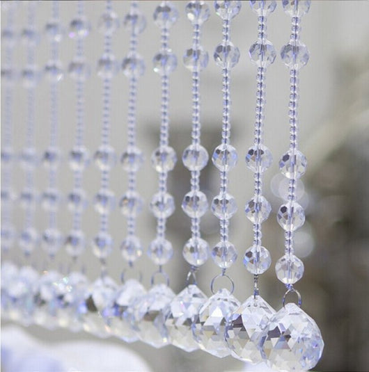 Clear faceted crystal ball bead, possibly K9 crystal, with a hole for stringing, against a dark background. - Image 2