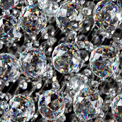 Clear faceted crystal ball bead, possibly K9 crystal, with a hole for stringing, against a dark background. - Image 4
