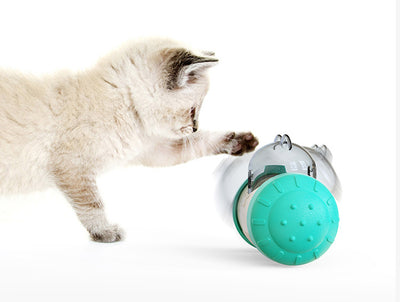 Pink and white bear-shaped pet treat dispenser toy filled with kibble, with a kitten and dog in the background. - Image 14
