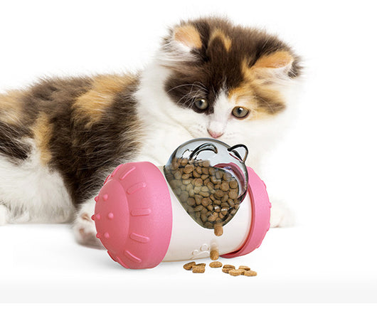 Pink and white bear-shaped pet treat dispenser toy filled with kibble, with a kitten and dog in the background. - Image 10