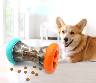 Blue and orange pet food leakage toy, shaped like a dumbbell, filled with kibble, with a bulldog in the background. - Image 2