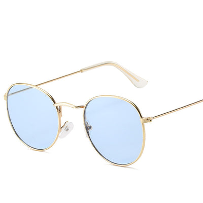 Retro oval sunglasses with pink lenses and a gold metal frame, featuring clear temple tips. - Image 11