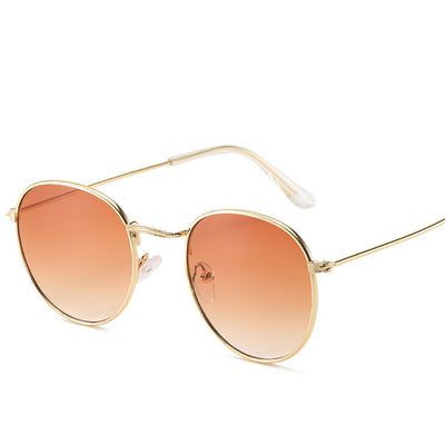 Retro oval sunglasses with pink lenses and a gold metal frame, featuring clear temple tips. - Image 5