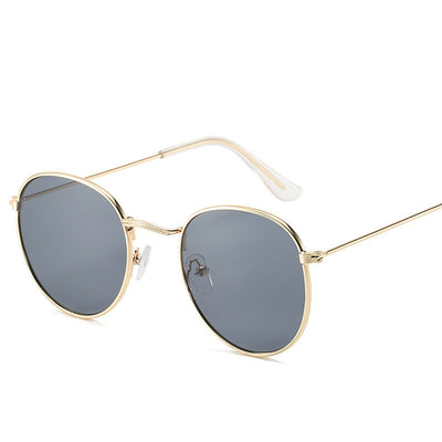 Retro oval sunglasses with pink lenses and a gold metal frame, featuring clear temple tips. - Image 3