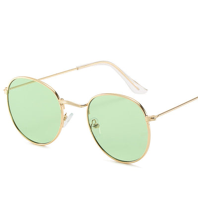 Retro oval sunglasses with pink lenses and a gold metal frame, featuring clear temple tips. - Image 8