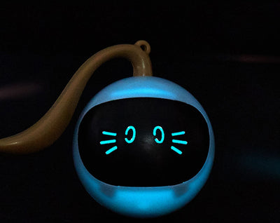 Yellow spherical cat toy with a black face panel, glowing blue eyes and whiskers, and a grey tail. - Image 16