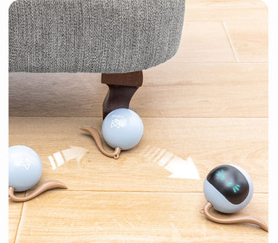Yellow spherical cat toy with a black face panel, glowing blue eyes and whiskers, and a grey tail. - Image 17