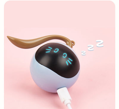 Yellow spherical cat toy with a black face panel, glowing blue eyes and whiskers, and a grey tail. - Image 7