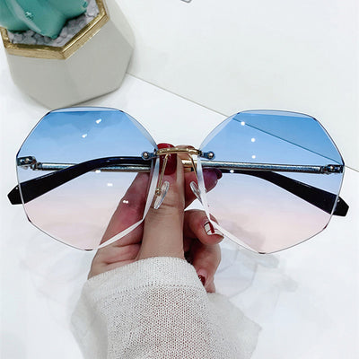 Ladies' cut-edge polygonal sunglasses with gradient purple-to-pink lenses and black temples, held by a hand. - Image 4