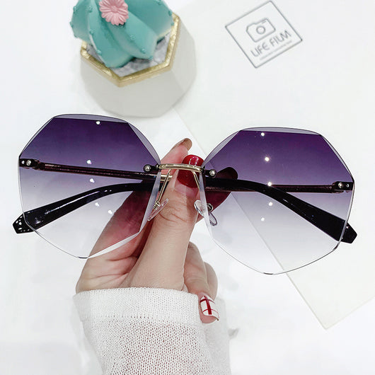 Ladies' cut-edge polygonal sunglasses with gradient purple-to-pink lenses and black temples, held by a hand. - Image 6