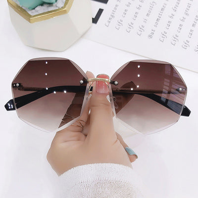 Ladies' cut-edge polygonal sunglasses with gradient purple-to-pink lenses and black temples, held by a hand. - Image 5