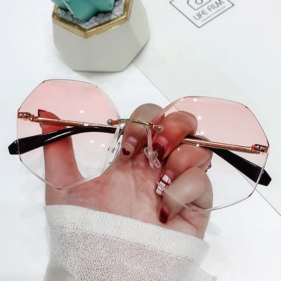Ladies' cut-edge polygonal sunglasses with gradient purple-to-pink lenses and black temples, held by a hand. - Image 7