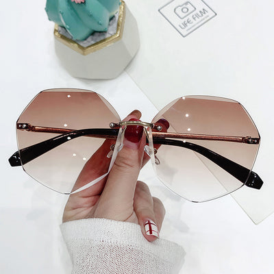 Ladies' cut-edge polygonal sunglasses with gradient purple-to-pink lenses and black temples, held by a hand. - Image 8