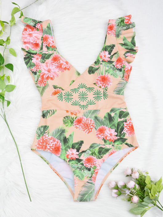 Women's peach one-piece swimsuit with deep V-neck and ruffled straps, featuring a vibrant floral and leaf print. - Image 12