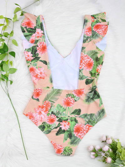 Women's peach one-piece swimsuit with deep V-neck and ruffled straps, featuring a vibrant floral and leaf print. - Image 2