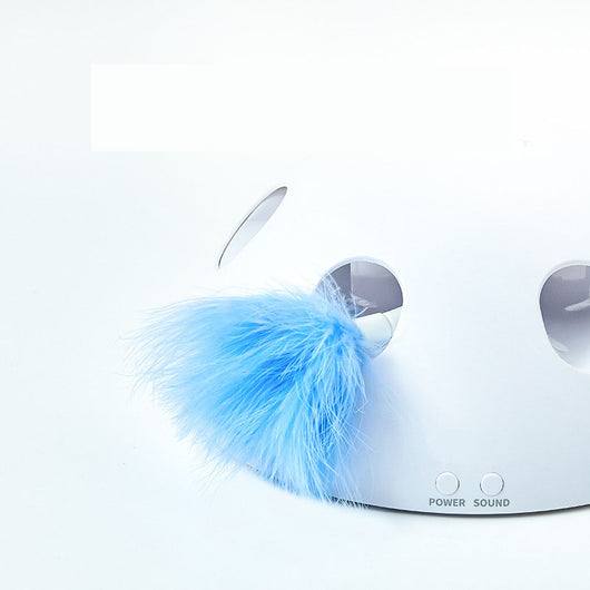 White cat playing with a white dome-shaped electric cat toy, featuring blue feathers visible through openings. - Image 3