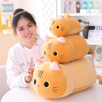 Cute orange cat plush doll with pink ears, black eyes, and embroidered whiskers, resting on a white book. - Image 4